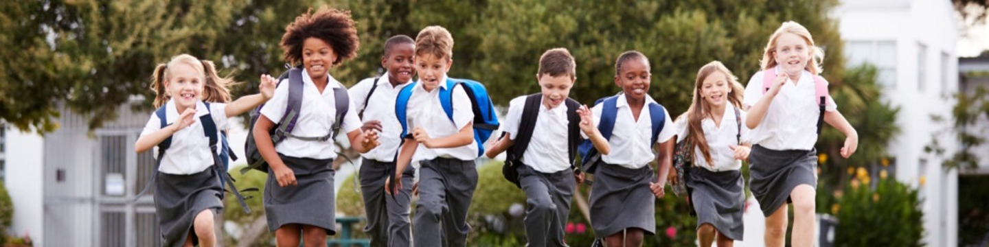 Primary aged school children running.