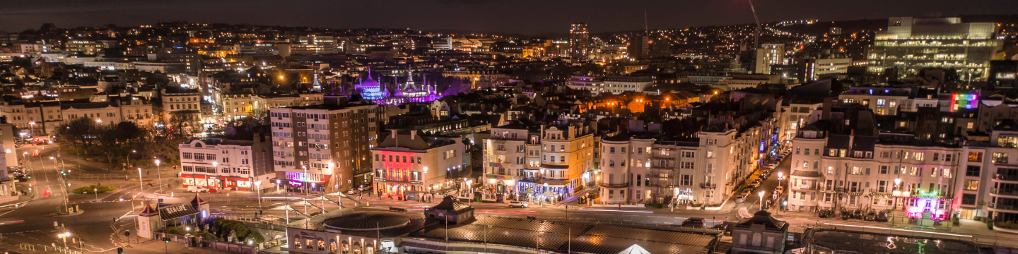 Brighton & Hove's seafront lit up at night.