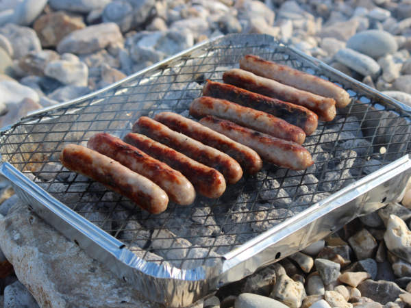 Images of sausages cooking on a BBQ