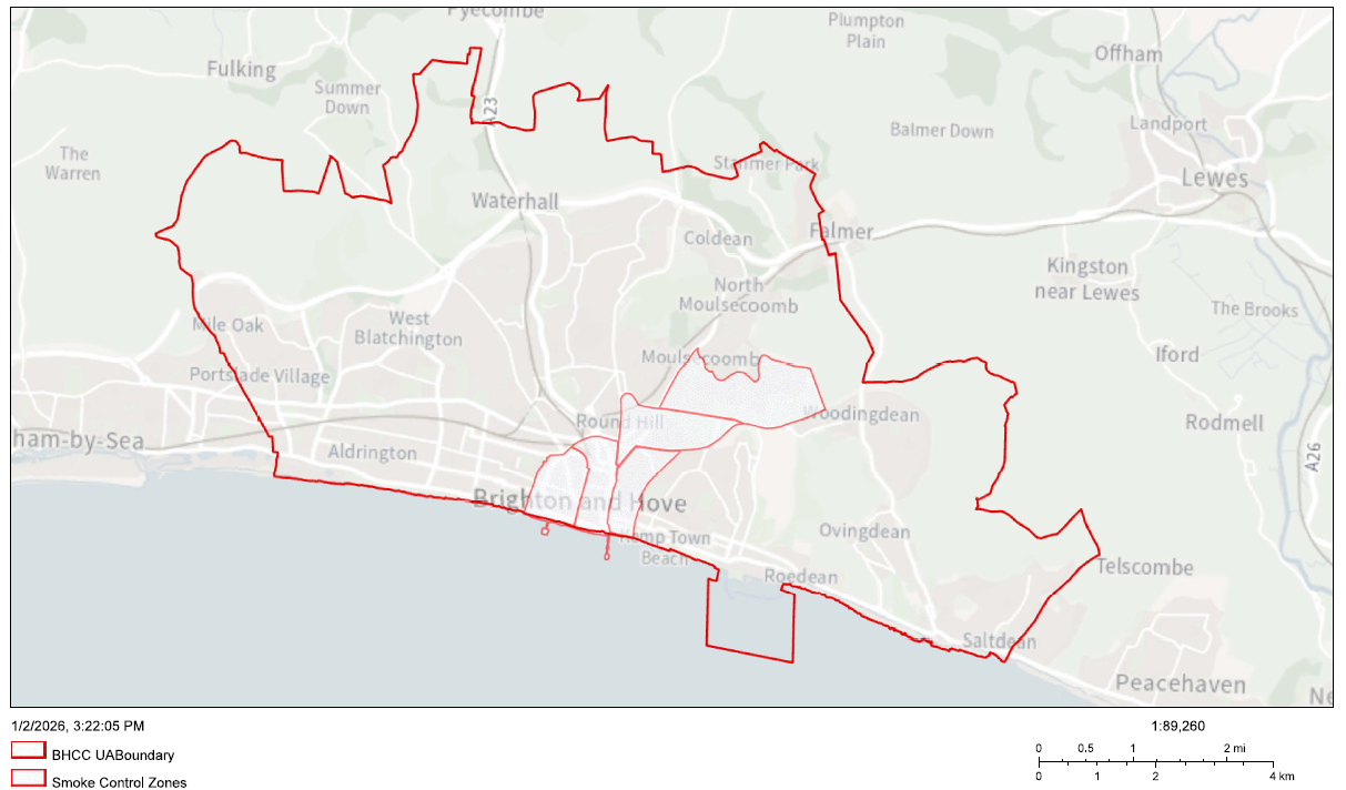 A map of Brighton and Hove with red outlines showing smoke control zones. The smaller inner shapes represent the current smoke control areas, while the larger outer boundary marks the proposed expansion to cover the entire city. The map includes surrounding areas such as Lewes, Peacehaven, and Portslade, with a scale bar at the bottom right indicating distances in miles and kilometers.
